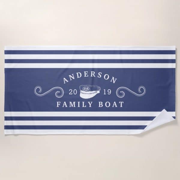 Navy Blue And White Striped Beach Towel With The Anderson Family Boat Logo. The Logo Includes A Captain'S Hat And The Years 2019.