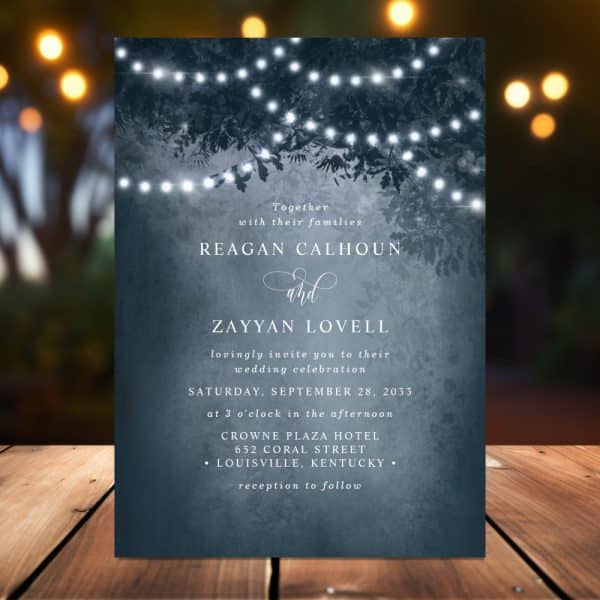 Wedding Invitation For Reagan Calhoun And Zayyan Lovell, Featuring A Dark Blue Background With String Lights And Tree Branches.