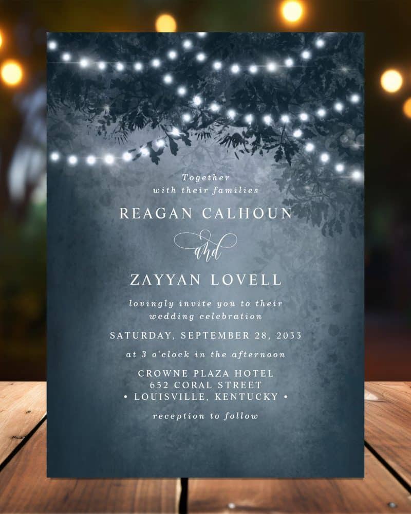 Wedding invitation for Reagan Calhoun and Zayyan Lovell, featuring a dark blue background with string lights and tree branches.
