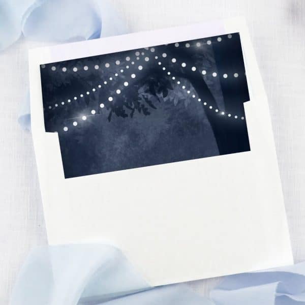 White Envelope Liner With A Dark Blue Image Of String Lights On A Tree At Night.