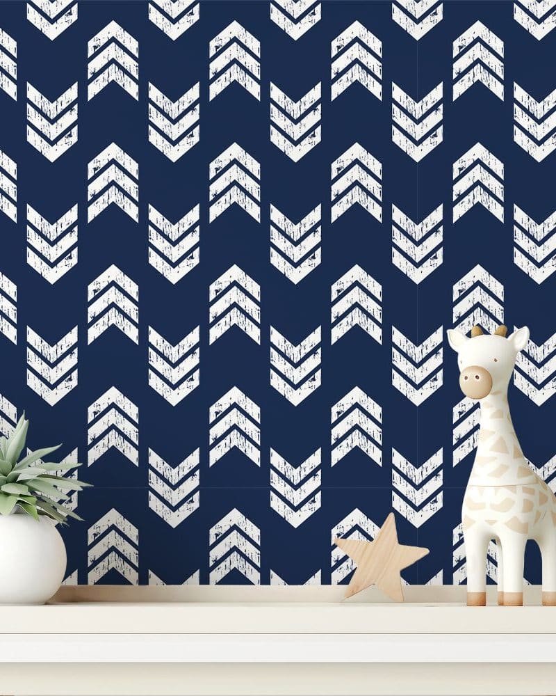 A navy blue wall with a white distressed chevron pattern.