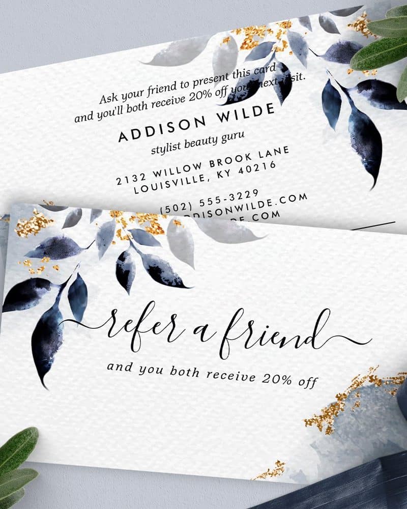 Refer a friend card offering 20% off for both referrer and friend. Features blue watercolor leaves and gold accents.