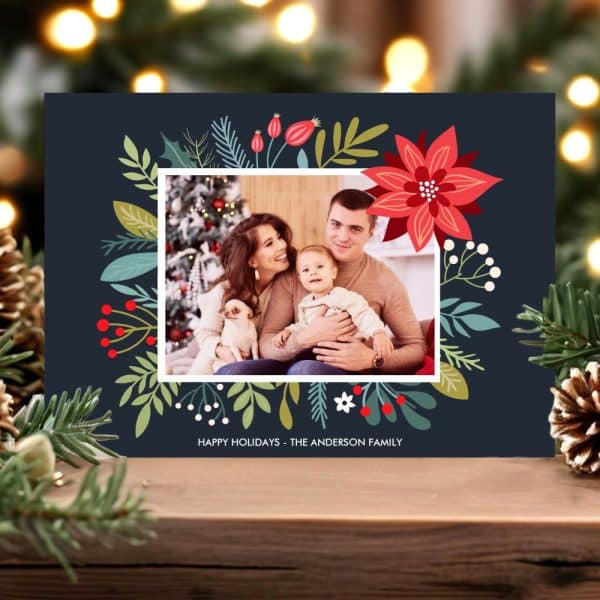 Christmas Card Featuring A Family Photo Of A Mother, Father, And Baby, Surrounded By A Floral Design.