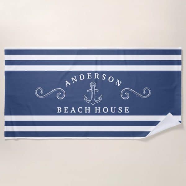 Blue And White Striped Beach Towel With The Name Anderson Beach House And An Anchor Graphic.