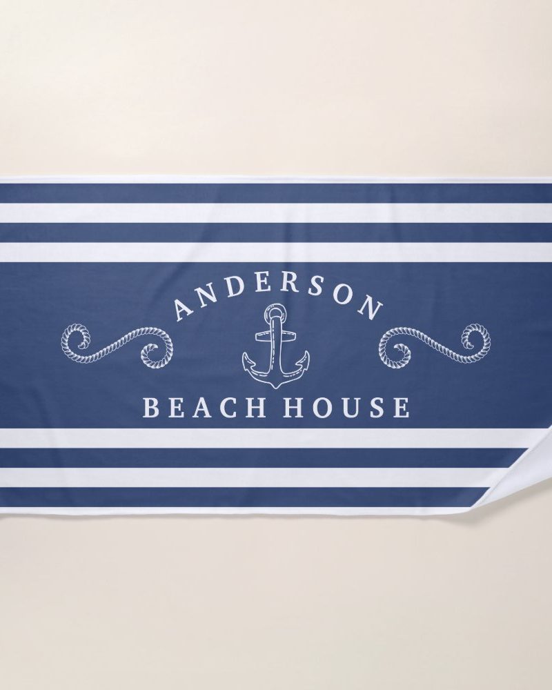 Blue and white striped beach towel with the name Anderson Beach House and an anchor graphic.