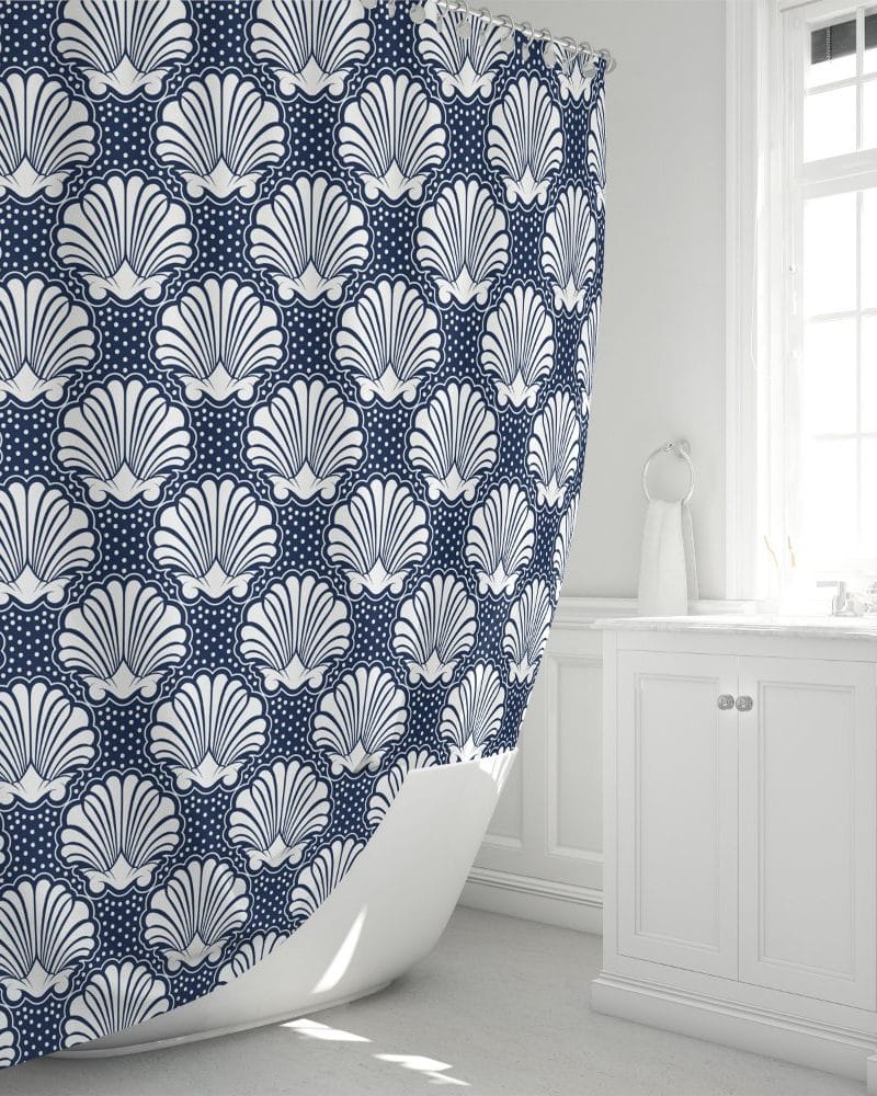 Navy blue shower curtain with a repeating pattern of white stylized seashells.