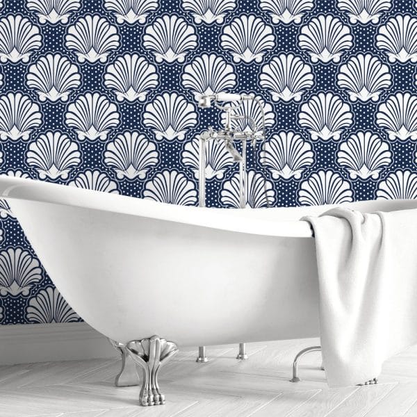 White Clawfoot Bathtub In Front Of A Navy Blue Wall With A White Seashell Pattern.