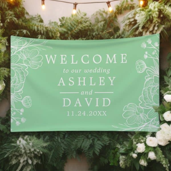 Light Green Wedding Welcome Banner With White Floral Designs And The Names Ashley And David, And Wedding Date.