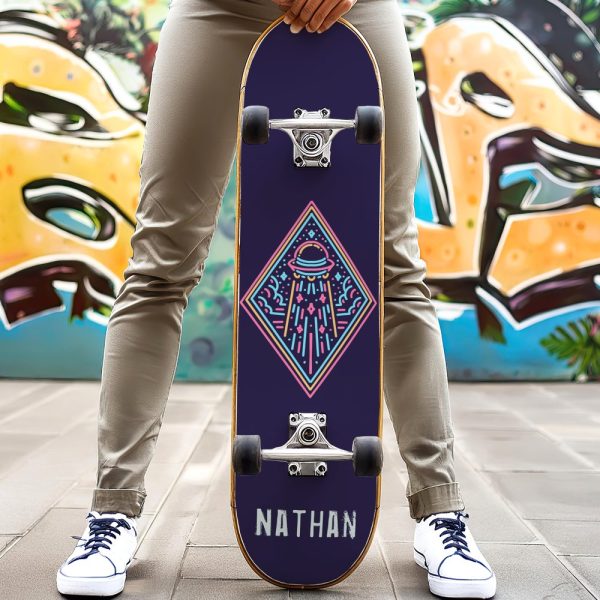 Person Holding A Dark Purple Skateboard With A Neon Design Of A Ufo And The Name Nathan.