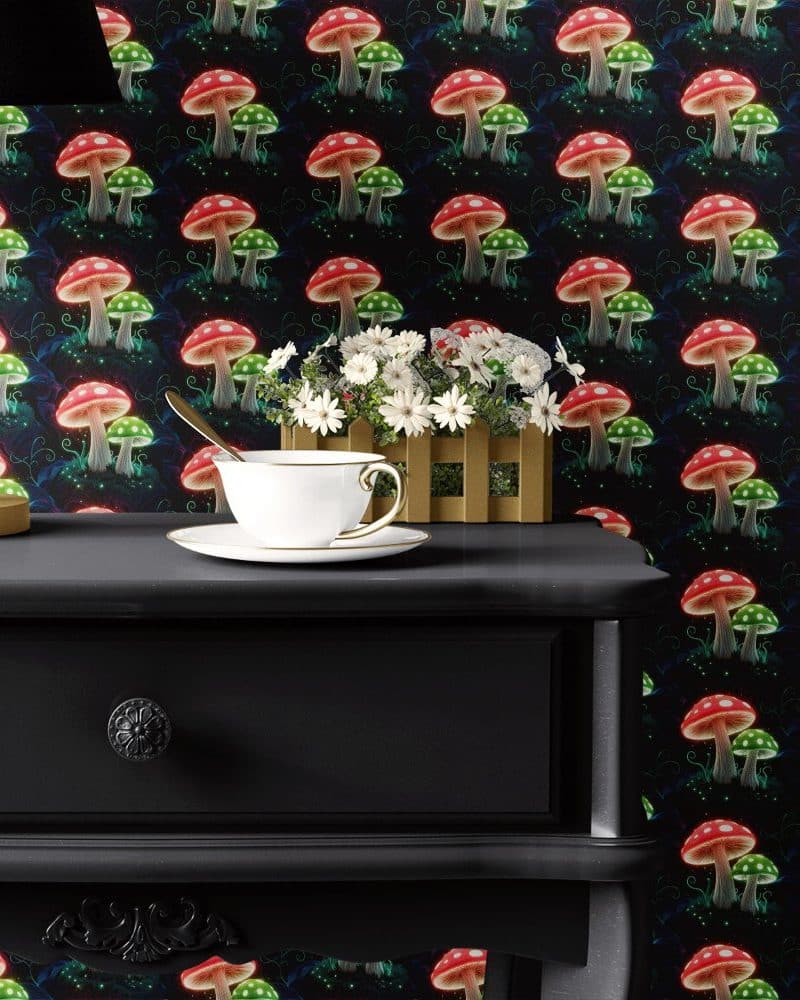 Teacup and saucer on a dark wooden side table against a wall with a repeating pattern of glowing red and green mushrooms.