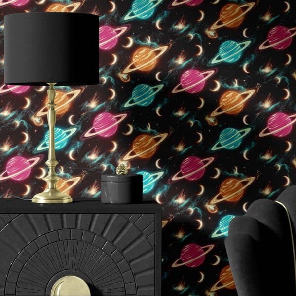 Black Dresser With A Gold Lamp And Decorative Box Against A Dark Wallpaper Featuring A Repeating Pattern Of Neon Planets And Stars.