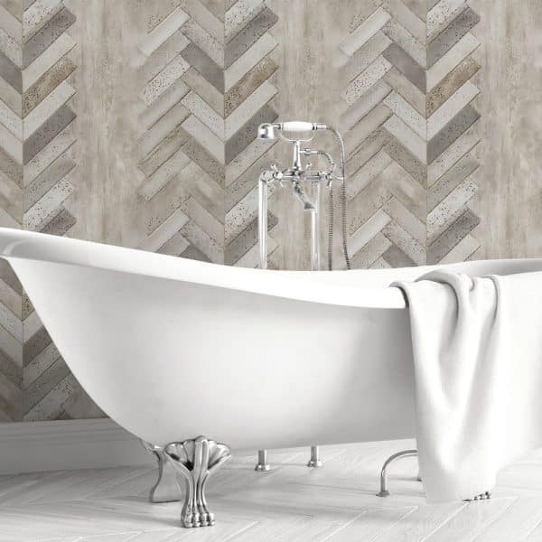 White Clawfoot Bathtub In Front Of A Herringbone Patterned Wall.