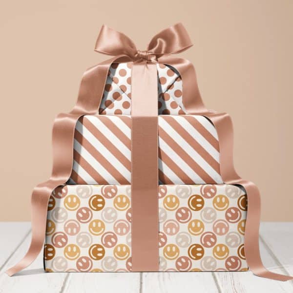 Stack Of Three Gifts With Rose Gold Ribbon.