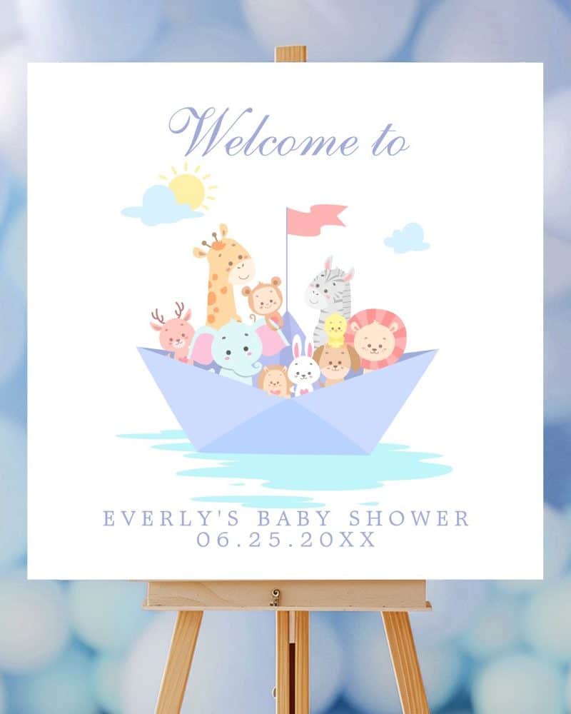 A baby shower sign featuring various cartoon animals in a paper boat. The sign says Welcome to Everly's Baby Shower.