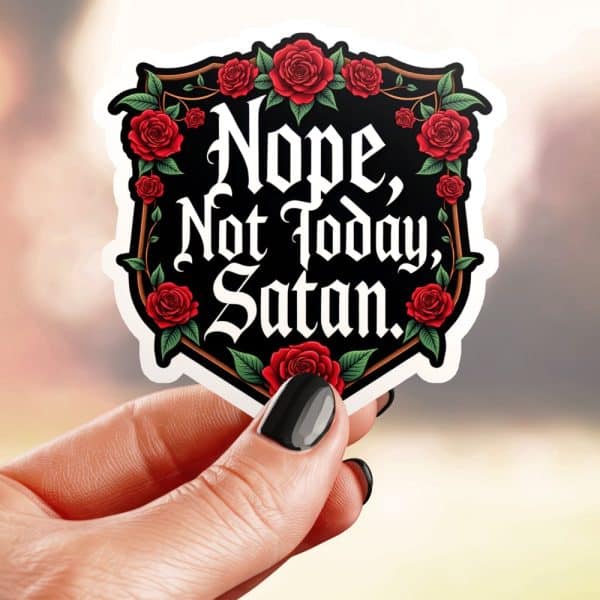A Hand Holds A Sticker With A Black Shield Shape Bordered With Red Roses And The Text Nope, Not Today, Satan In A Gothic Style Font.
