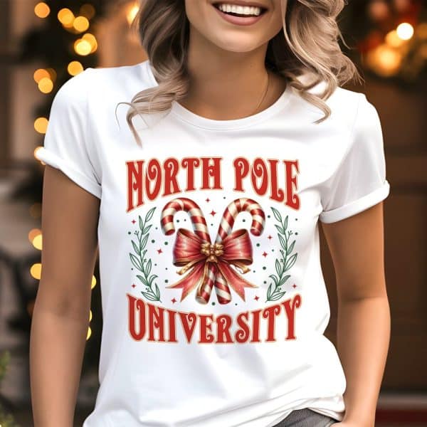 White T-Shirt With A North Pole University Design Featuring Candy Canes Tied With A Bow.
