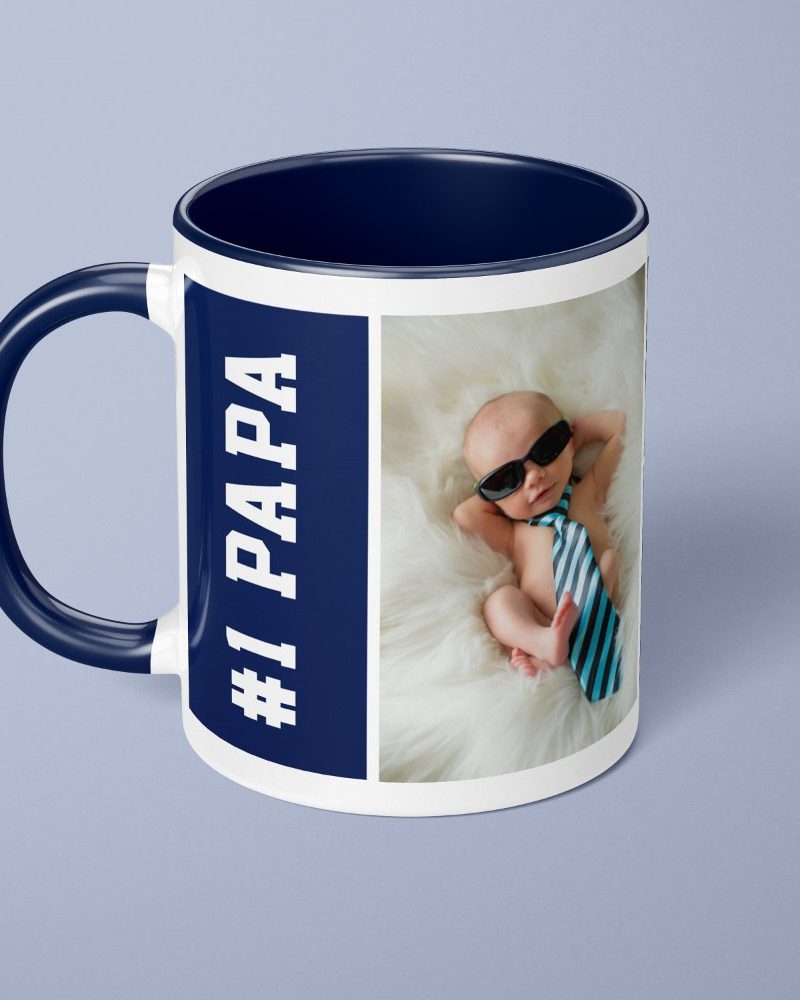 Navy blue mug with a picture of a baby wearing sunglasses and a tie, and the text #1 PAPA.