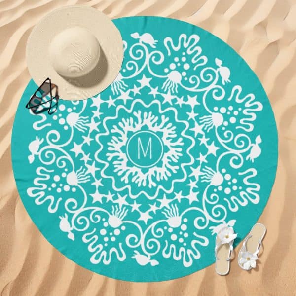 Teal Round Beach Towel With A White Mandala Design And The Initial M In The Center.