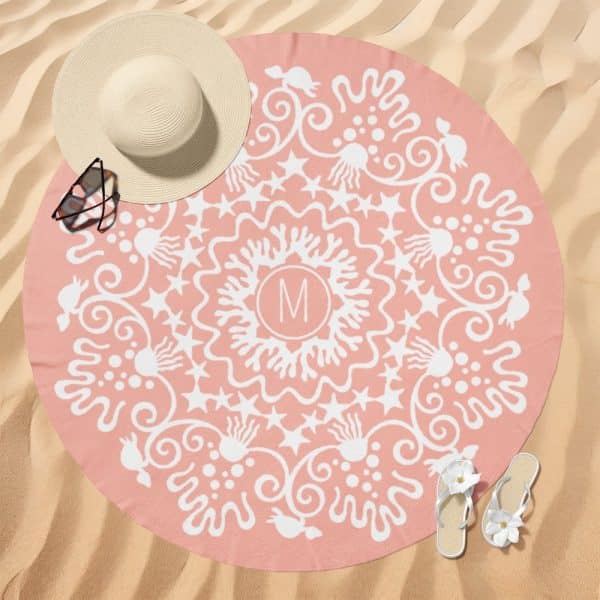 Pink Round Beach Towel With A White Mandala Design And Initial M In The Center.