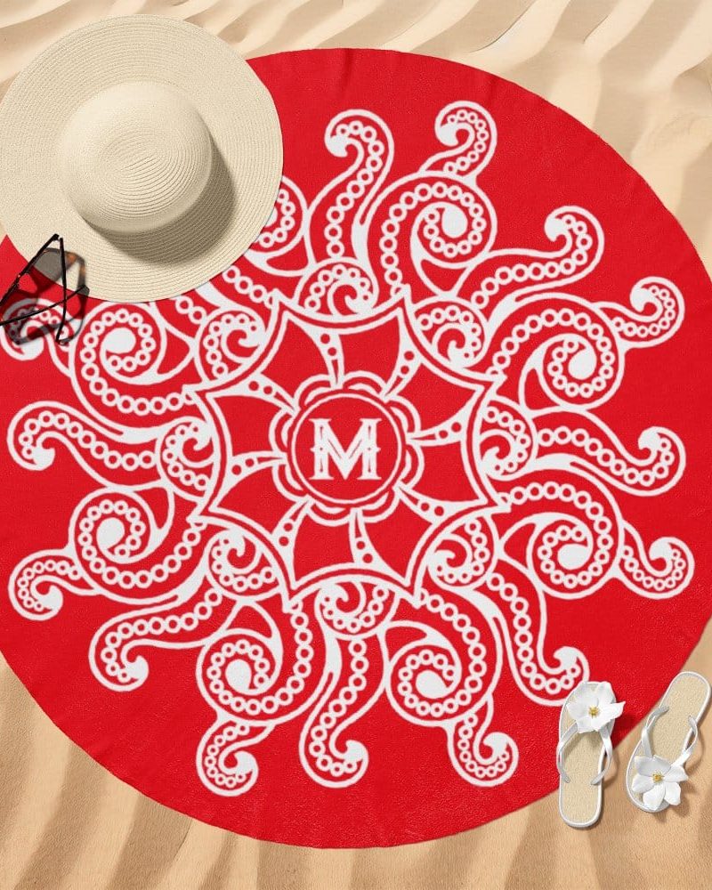 Red round beach towel with a white mandala design and a monogram in the center.