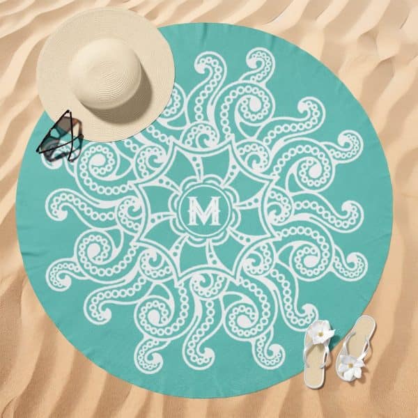 Teal Round Beach Towel With A White Mandala Design And A Monogrammed M In The Center.
