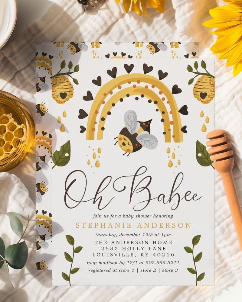 Baby shower invitation featuring a cute bee and rainbow design.