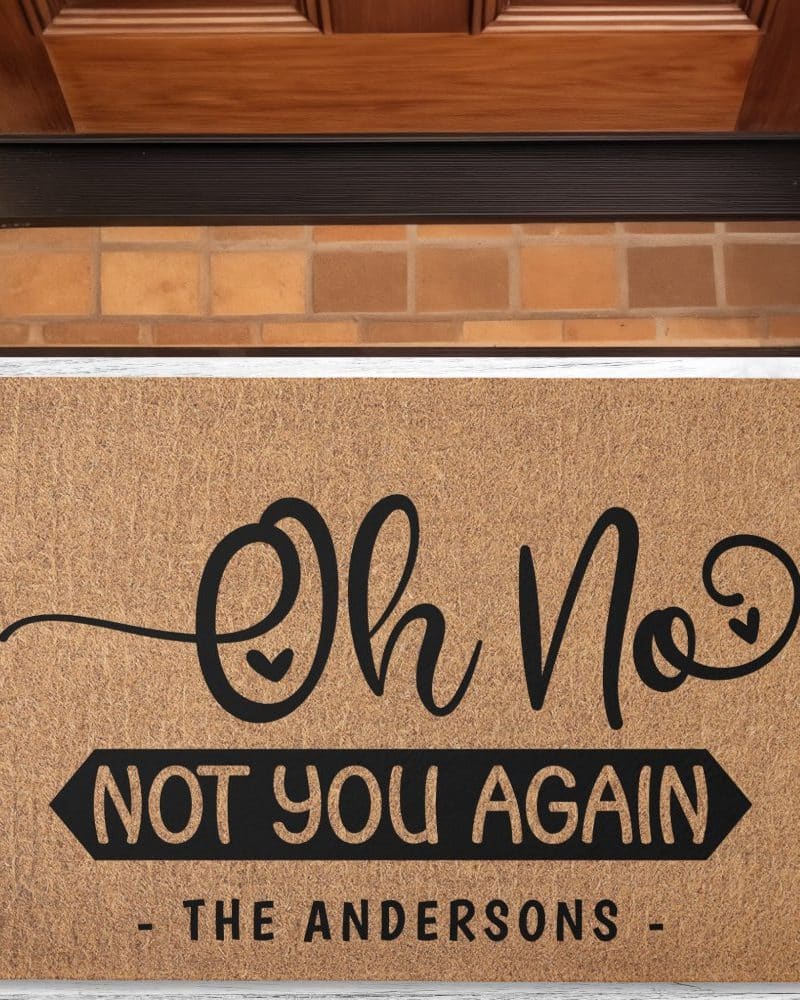 Tan welcome mat with black lettering that says Oh No, Not You Again, The Andersons.