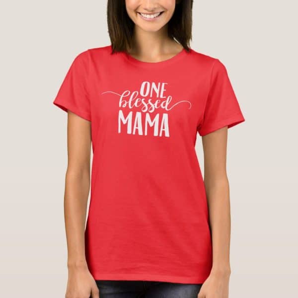 Woman Wearing A Red T-Shirt That Says One Blessed Mama In White Lettering.