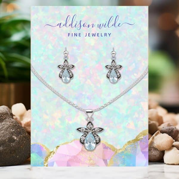 Silver Necklace And Earrings Set With Light Blue Teardrop Stones.