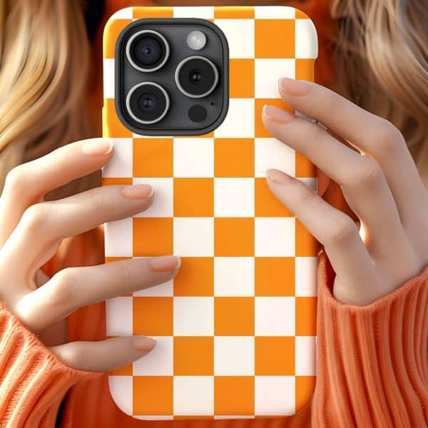 Hands Holding An Orange And White Checkered Phone Case.