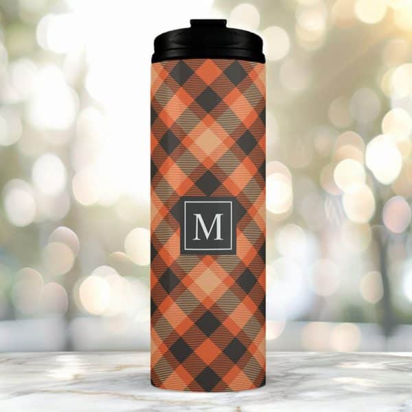 Orange And Black Plaid Tumbler With A Black Lid And The Letter M In A Gray Square.