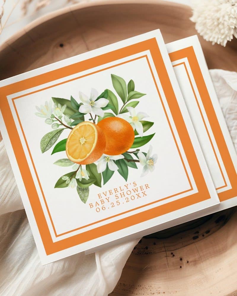 Orange blossoms and oranges on a baby shower invitation.