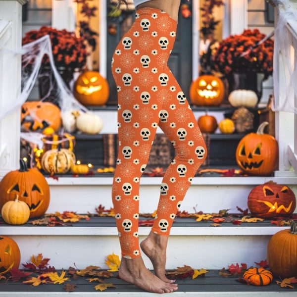 Person'S Legs Wearing Orange Leggings With A Halloween Pattern Of Skulls And Spiderwebs.