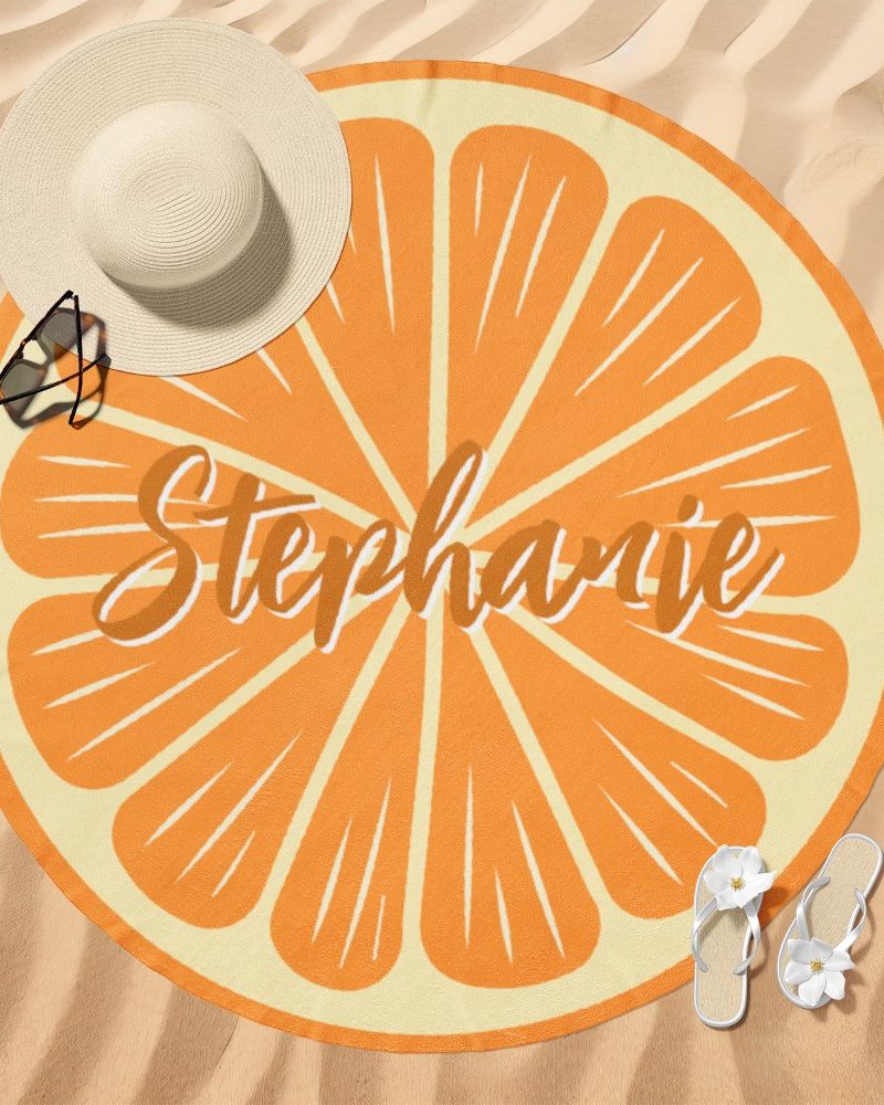 Round beach towel with an orange slice design and the name Stephanie.
