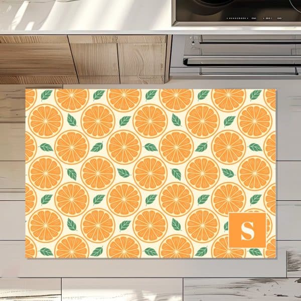 Orange Slice Patterned Floor Mat With A Letter S In The Corner.