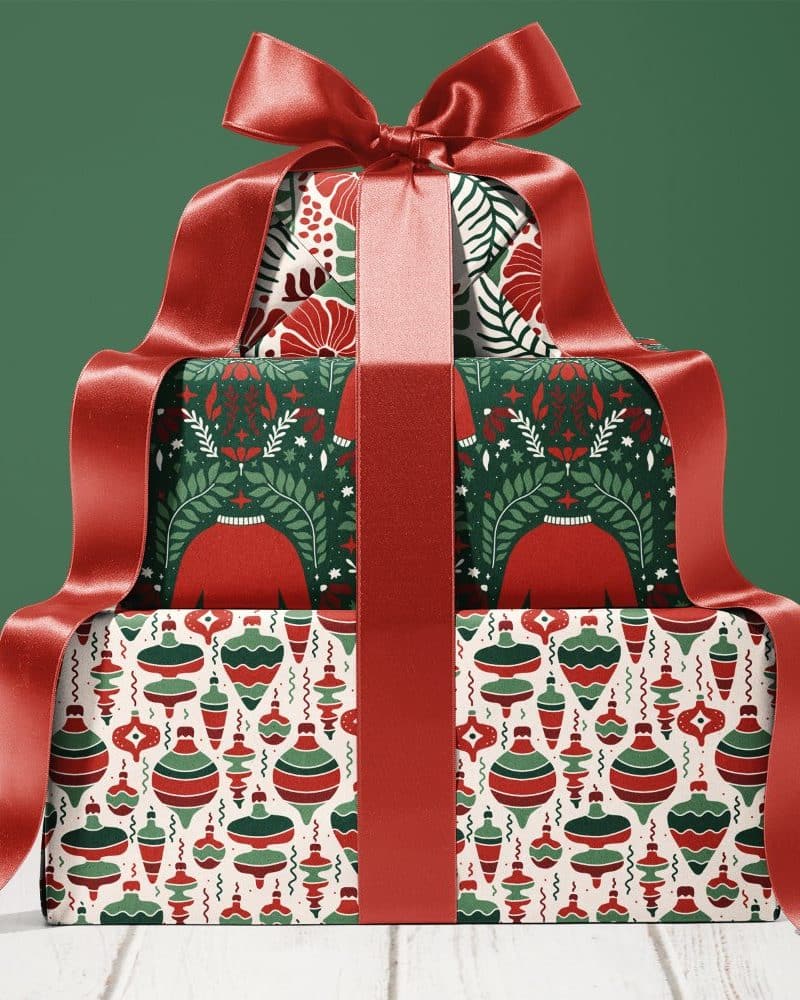 Stack of three Christmas presents tied with a large red ribbon.
