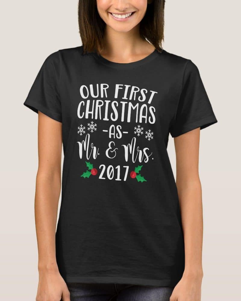 Woman wearing a black t-shirt that says Our First Christmas as Mr. & Mrs. 2017.