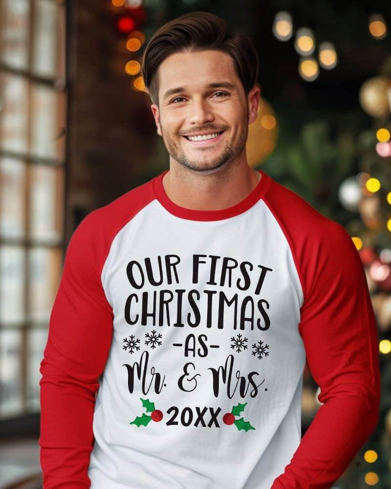 Man in a red and white Christmas sweater that says Our First Christmas as Mr. & Mrs. 20XX.