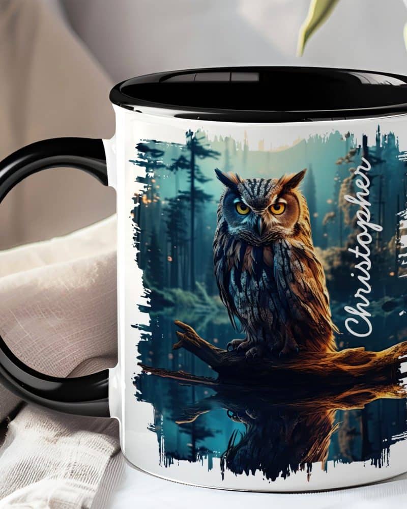 Black-handled mug with a personalized design: an owl perched on a branch reflected in water, set against a dark forest background.
