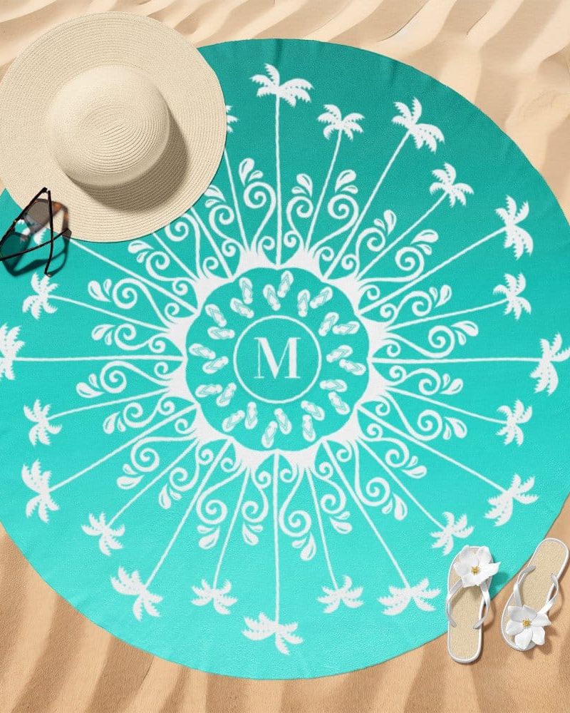 Teal round beach towel with a mandala design featuring palm trees, flip-flops, and a monogram.