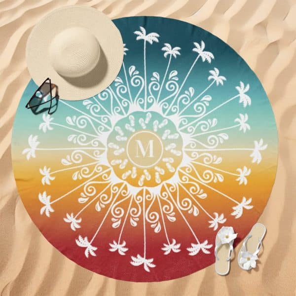 A Round Beach Towel With A Colorful Ombre Design Featuring Palm Trees And Flip-Flops Surrounding A Central Monogram.