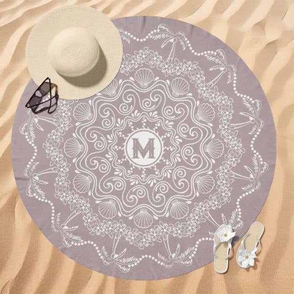 Purple Round Beach Towel With A White Mandala Design, Featuring Seashells, Flowers, And Palm Trees, And A Central Monogram Of The Letter M.