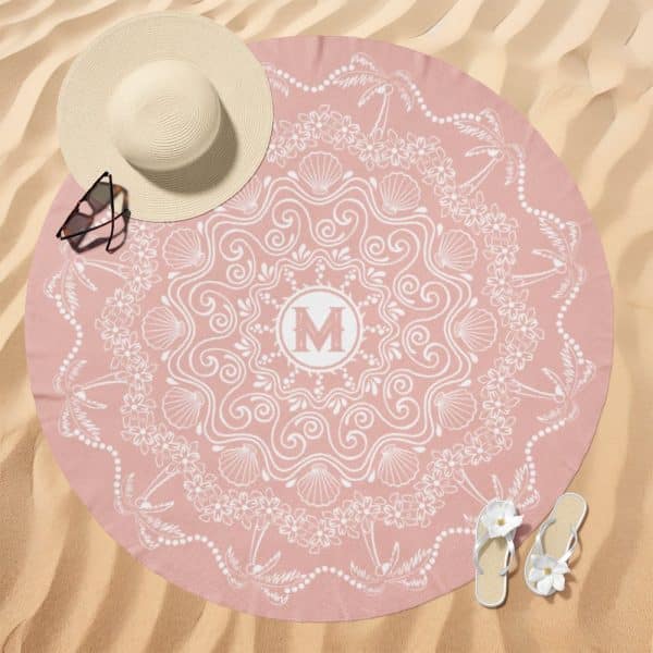 Pink Round Beach Towel With A White Mandala Design And A Monogrammed M In The Center.