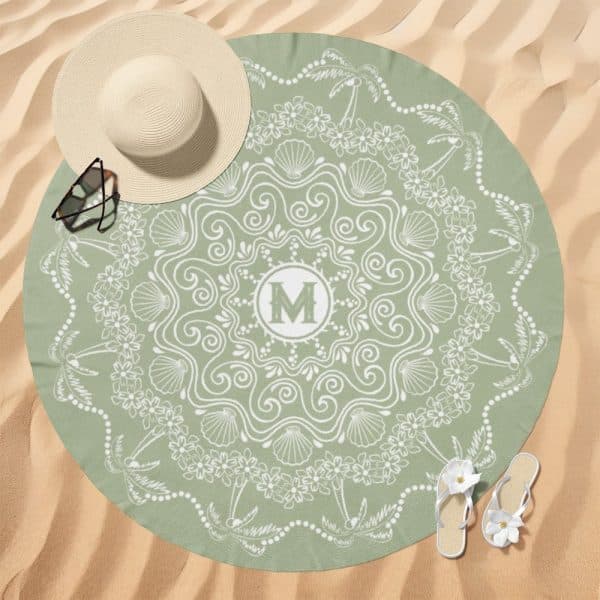 Sage Green Round Beach Towel With A White Mandala Design Featuring Seashells, Flowers, And Palm Trees, And A Monogrammed Initial M In The Center.