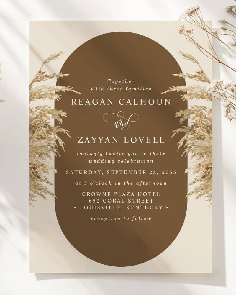 Wedding invitation for Reagan Calhoun and Zayyan Lovell, featuring pampas grass design.