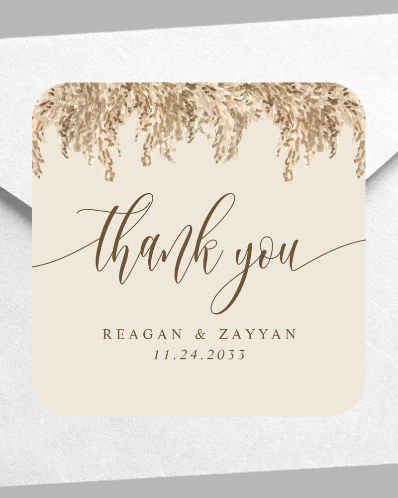 Beige thank you card with brown calligraphy, pampas grass design, and wedding date.