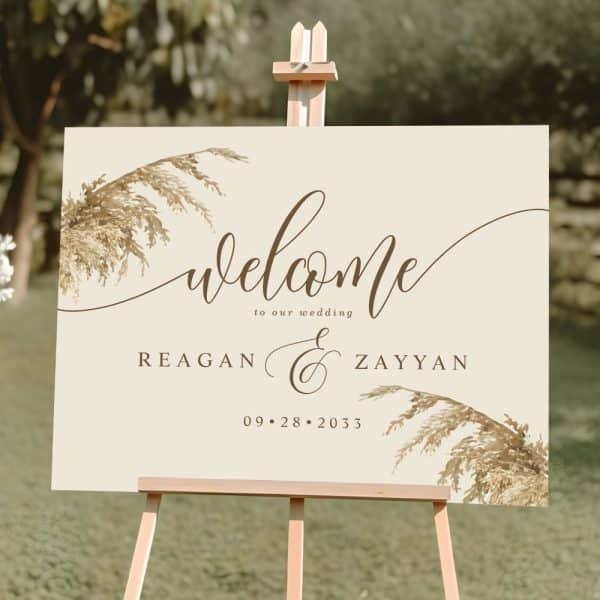 Beige Wedding Welcome Sign With Pampas Grass Design, Announcing Reagan And Zayyan'S Wedding On September 28, 2033.
