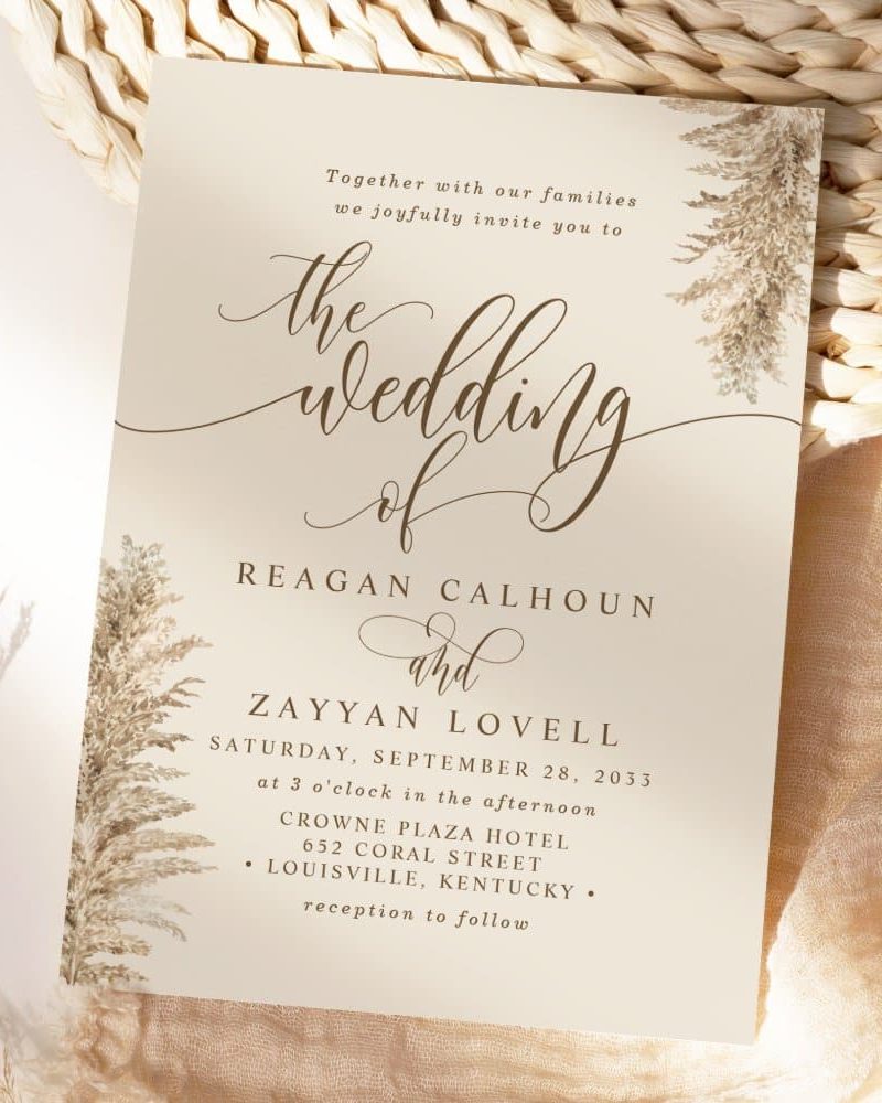 Wedding invitation for Reagan Calhoun and Zayyan Lovell, September 28, 2033, at Crowne Plaza Hotel in Louisville, Kentucky. Pamphlet features dried floral design.