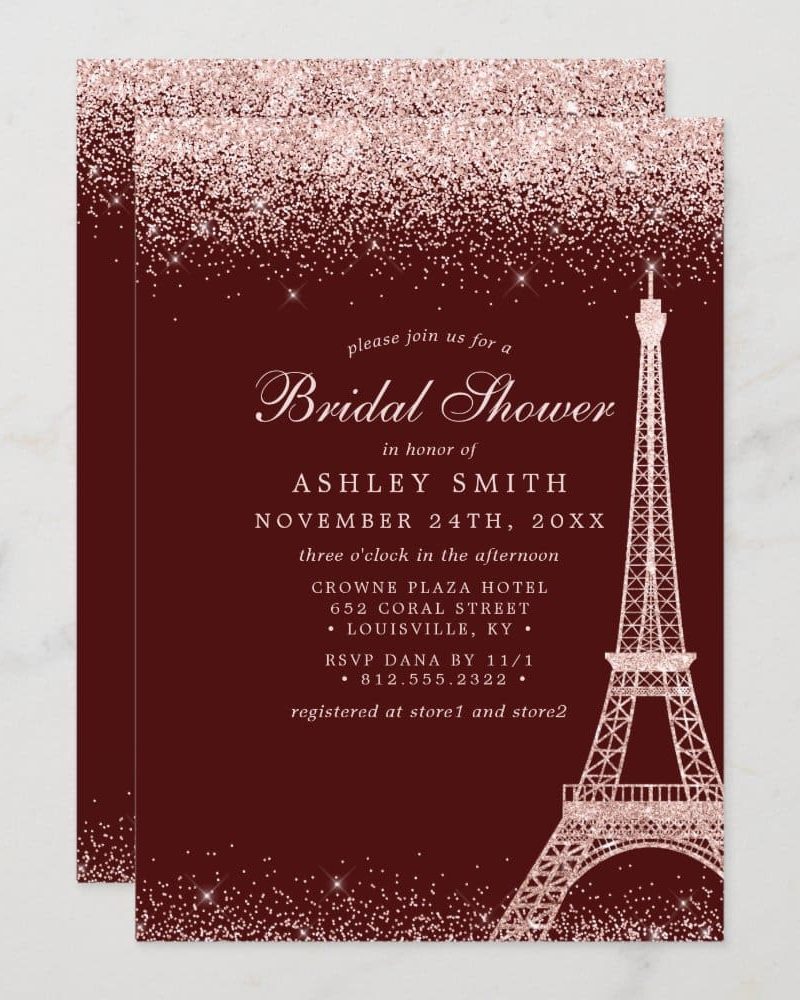 Bridal shower invitation for Ashley Smith, featuring the Eiffel Tower and rose gold glitter on a burgundy background.
