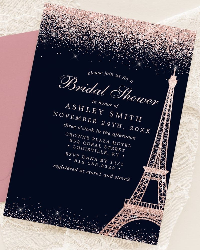 Bridal shower invitation for Ashley Smith, featuring a rose gold Eiffel Tower on a dark blue background with glitter.